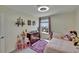 Well-lit bedroom with charming decor, including a cute princess castle and fun purple rug at 13234 Great Plains Dr, Riverview, FL 33579
