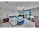 Cozy bedroom with large window, ceiling fan, and a comfortable bed at 13234 Great Plains Dr, Riverview, FL 33579