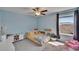 Inviting bedroom with ceiling fan and a window to enjoy the sunlight at 13234 Great Plains Dr, Riverview, FL 33579