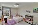 Bright bedroom with a ceiling fan, large window, and decor; ideal for children at 13234 Great Plains Dr, Riverview, FL 33579