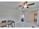 Functional bonus room featuring a table, modern ceiling fan, and direct access to another room with storage at 13234 Great Plains Dr, Riverview, FL 33579