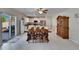 Open dining area features a wood table, chairs, and view of the kitchen and outdoor patio with sliding glass door at 13234 Great Plains Dr, Riverview, FL 33579