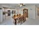 Bright dining room with wood table, chairs, and a view of the kitchen with stainless steel appliances and granite countertops at 13234 Great Plains Dr, Riverview, FL 33579