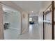 Bright hallway featuring white tile flooring, coat rack, and access to living spaces at 13234 Great Plains Dr, Riverview, FL 33579