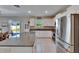 Bright kitchen boasts granite countertops, stainless steel appliances, and a view of the backyard through a sliding glass door at 13234 Great Plains Dr, Riverview, FL 33579