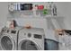 Laundry room featuring front load washer and dryer, wire shelving, storage and overhead lighting at 13234 Great Plains Dr, Riverview, FL 33579