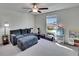 Inviting living room featuring comfortable gray sofa, ceiling fan, and carpet floors at 13234 Great Plains Dr, Riverview, FL 33579