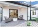 Covered patio with outdoor seating, sleek pavers, and an entrance to the home's living space at 14256 Eagle Branch Dr, Nokomis, FL 34275