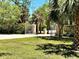 Landscaped view of the property's ornate gated entrance, offering privacy and curb appeal at 1516 Bayshore Blvd, Dunedin, FL 34698