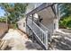 Charming backyard with wooden stairs leading to a second-story deck at 1557 Robinson N Dr, St Petersburg, FL 33710