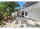 Backyard with mature trees, white exterior, and an exterior staircase at 1557 Robinson N Dr, St Petersburg, FL 33710