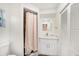 This bathroom features a single sink vanity, toilet, shower with curtain, and storage at 1557 Robinson N Dr, St Petersburg, FL 33710