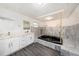 This bathroom features a tub, double sink vanity, tiled walls, and ample counter space at 1557 Robinson N Dr, St Petersburg, FL 33710