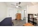 This bedroom features gray floors, a ceiling fan, a bathroom with shower, and back door access at 1557 Robinson N Dr, St Petersburg, FL 33710