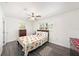 Cozy bedroom with a ceiling fan, natural lighting, and wood-look flooring at 1557 Robinson N Dr, St Petersburg, FL 33710