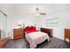 Comfortable bedroom with a ceiling fan, natural lighting, and wood-look flooring at 1557 Robinson N Dr, St Petersburg, FL 33710