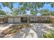 Charming single-story home with stone facade, two-car garage, and well-maintained front yard at 1557 Robinson N Dr, St Petersburg, FL 33710