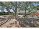 Inviting single-story home with a stone exterior and landscaped front yard featuring mature trees at 1557 Robinson N Dr, St Petersburg, FL 33710