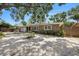 Single-story home featuring a stone facade, well-kept landscaping, and a two-car garage at 1557 Robinson N Dr, St Petersburg, FL 33710