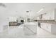 Bright, open kitchen with a large island, stainless appliances, and marble floors leading to the living area at 1557 Robinson N Dr, St Petersburg, FL 33710