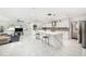 Bright kitchen with quartz countertops, mosaic backsplash, stainless appliances, and marble tile floors at 1557 Robinson N Dr, St Petersburg, FL 33710