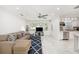 Modern living space featuring tile floors, a comfortable sofa, and seamless flow to the kitchen at 1557 Robinson N Dr, St Petersburg, FL 33710