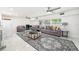 Spacious living room with a fireplace, tile flooring, modern decor, and abundant natural light at 1557 Robinson N Dr, St Petersburg, FL 33710