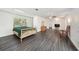 Spacious main bedroom features hardwood floors, ceiling fan, natural light, and ensuite bathroom at 1557 Robinson N Dr, St Petersburg, FL 33710