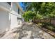 Long side yard with white rock landscaping and mature trees at 1557 Robinson N Dr, St Petersburg, FL 33710