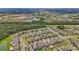 Expansive aerial view of a vibrant community with lush greenery, ponds and single Gathering homes at 17331 White Mangrove Dr, Wimauma, FL 33598
