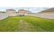 Expansive backyard with a well-maintained lawn and a white vinyl fence at 17331 White Mangrove Dr, Wimauma, FL 33598