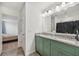 Bathroom with double sinks, granite countertops, and updated cabinetry at 17331 White Mangrove Dr, Wimauma, FL 33598