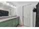 Bathroom featuring granite countertops, updated cabinets, and neutral tile flooring at 17331 White Mangrove Dr, Wimauma, FL 33598