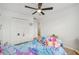 Cozy bedroom with a ceiling fan, closet, and a twin bed adorned with a mermaid comforter and plush toys at 17331 White Mangrove Dr, Wimauma, FL 33598