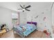 bedroom with mermaid themed decor, wood floors and ceiling fan at 17331 White Mangrove Dr, Wimauma, FL 33598