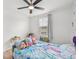 Bright bedroom featuring a ceiling fan, window with blinds, and a twin bed with colorful mermaid bedding at 17331 White Mangrove Dr, Wimauma, FL 33598