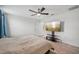 Spacious bedroom with ceiling fan and wood floors, and view of outdoor space at 17331 White Mangrove Dr, Wimauma, FL 33598