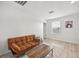 Bonus room featuring a small sofa, accent rug, table, and a large window at 17331 White Mangrove Dr, Wimauma, FL 33598