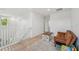 Open bonus room featuring neutral decor, a small sofa, and wood laminate flooring at 17331 White Mangrove Dr, Wimauma, FL 33598
