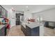 Bright kitchen featuring a large island, modern appliances, and a convenient pantry door at 17331 White Mangrove Dr, Wimauma, FL 33598