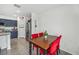 Charming dining area adjacent to a kitchen with stainless steel appliances and blue cabinetry at 17331 White Mangrove Dr, Wimauma, FL 33598