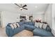 Spacious living room showcasing a sectional sofa and an adjacent dining area with bright red chairs at 17331 White Mangrove Dr, Wimauma, FL 33598