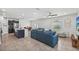 Open-concept living room with tile flooring, modern furnishings, and abundant natural light at 17331 White Mangrove Dr, Wimauma, FL 33598
