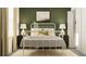 Stylish bedroom with a bed, lamps, and a cozy rug at 17611 Happytrails St, Land O Lakes, FL 34638