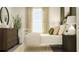 Bright bedroom featuring a bed, dresser, and window with curtains at 17611 Happytrails St, Land O Lakes, FL 34638