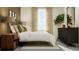 Well-lit bedroom with a bed, large dresser, and a bright window at 17611 Happytrails St, Land O Lakes, FL 34638
