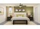 Beautiful bedroom with neutral tones, a ceiling fan, decorative pillows, and a dark bench at the foot of the bed at 17611 Happytrails St, Land O Lakes, FL 34638