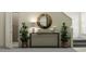 Elegant entryway with console table, round mirror, and decorative plants, creating a welcoming atmosphere at 17611 Happytrails St, Land O Lakes, FL 34638