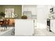 Modern kitchen featuring a white island with seating, stainless steel appliances, and a contemporary design at 17611 Happytrails St, Land O Lakes, FL 34638