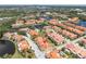 Aerial view of a neighborhood featuring beautiful lakes, green landscaping, a pool, and nearby city views at 19 Crescent S Pl, St Petersburg, FL 33711